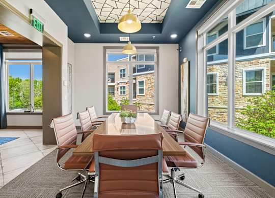 A conference room with a long table and chairs.