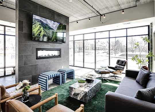 A modern living room with a flat screen TV mounted on the wall.