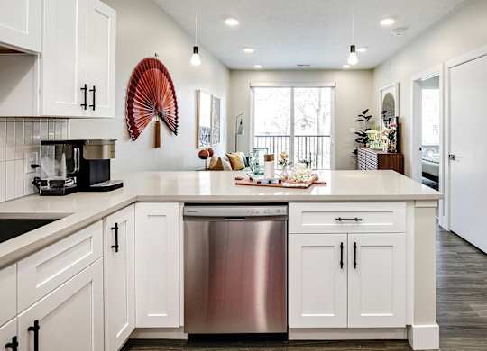 A modern kitchen with white cabinets and a large island.