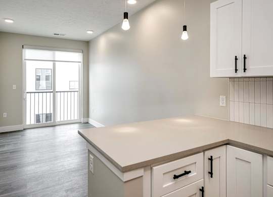 A kitchen with white cabinets and a countertop.