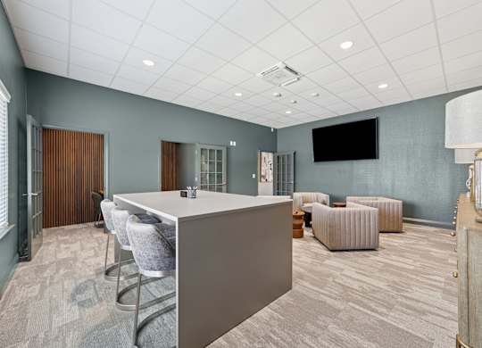 A conference room with a long table and chairs.