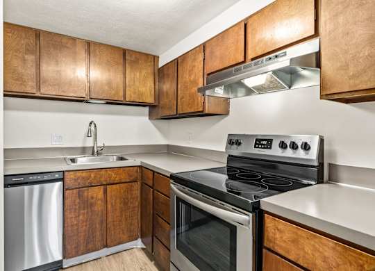 A modern kitchen with wooden cabinets and stainless steel appliances.