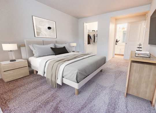 A bedroom with a bed, nightstand, and a carpeted floor.