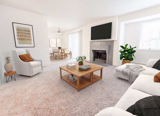 A living room with a fireplace, a couch, a chair, a coffee table, and a television.