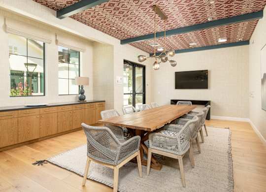 A dining room with a wooden table and chairs.