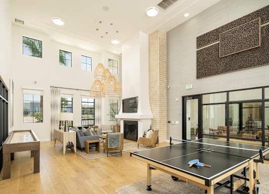 A ping pong table is in the middle of a living room.