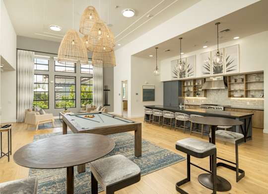 A modern dining room with a large table and chairs.