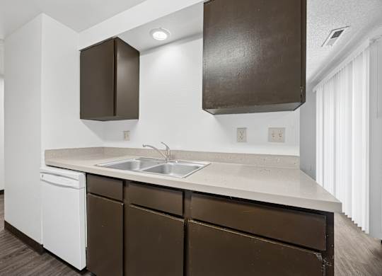 A kitchen with brown cabinets and white appliances.