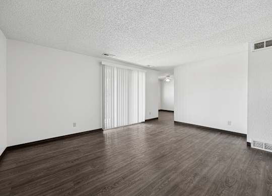 A room with wooden floors and white walls.