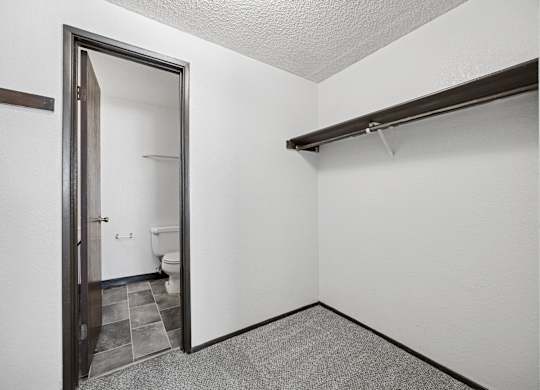 A bathroom with a toilet and sink is visible through an open door.
