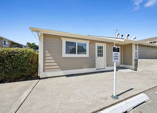 A small house with a sign that says