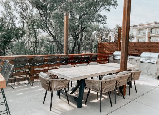 Outdoor BBQ Area with Large Dining Table at Presidio at River East, Texas