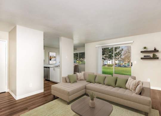 A living room with a couch, a coffee table, and a window.