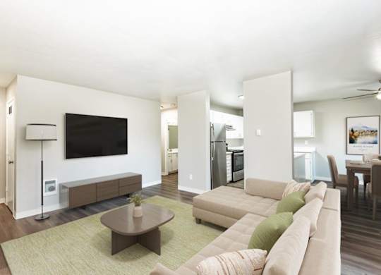 A living room with a brown coffee table and a large sectional sofa.
