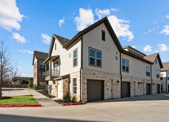 a house with a stone and white facade and a driveway at Lenox Grand, Austin