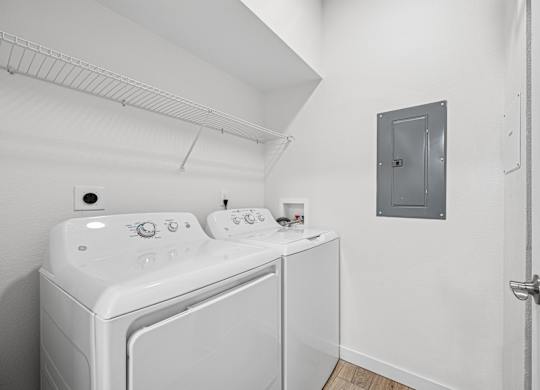 A white washing machine and dryer in a small laundry room.