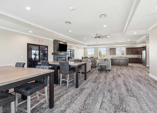 A spacious room with a long table and chairs.