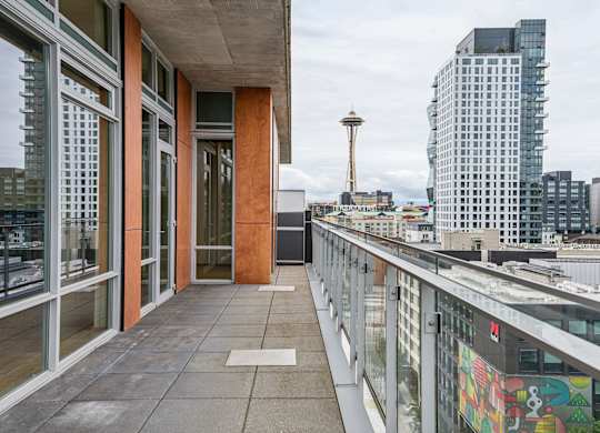 A balcony with a view of the Seattle Space Needle.