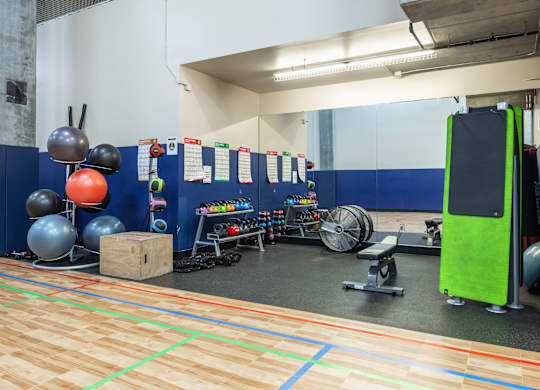 A gym with a variety of equipment including weights and resistance bands.