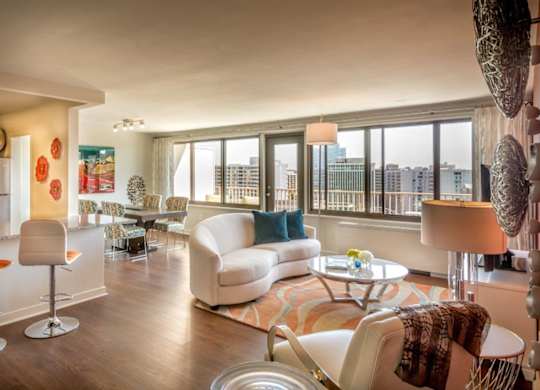 A living room with a white couch and a coffee table.