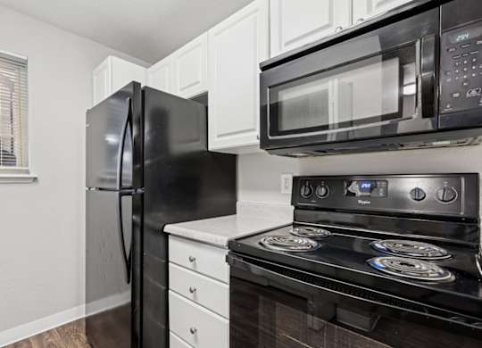 Kitchen With Black Appliances at Saratoga, Washington