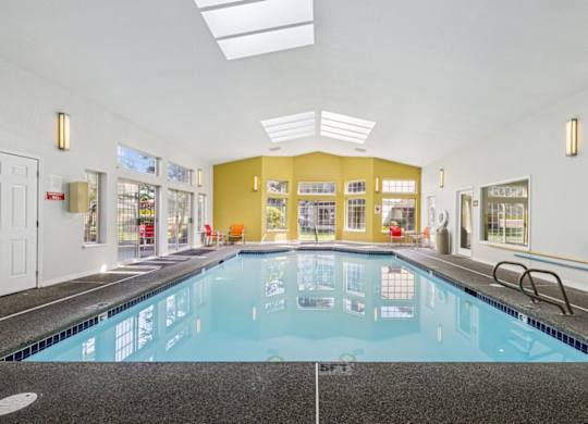 A large indoor swimming pool with a tiled floor. at Saratoga, Everett, WA, 98204