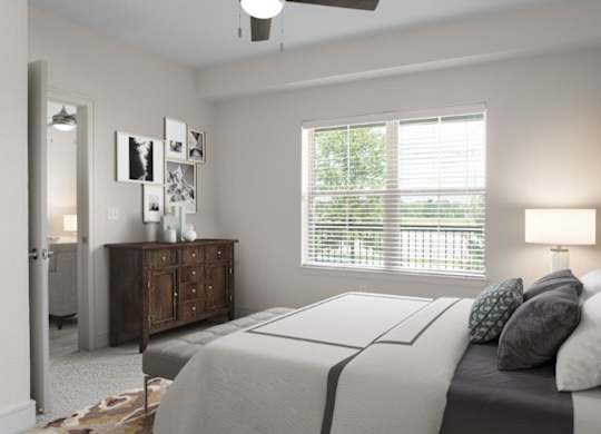 A bedroom with a bed, dresser, and window with blinds.