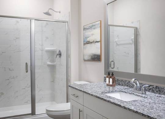 A bathroom with a marble toilet and a sink.