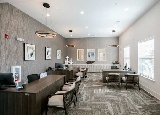 A reception area with a desk and chairs.