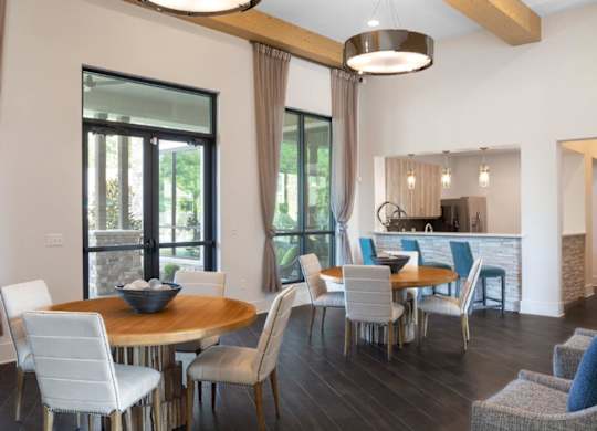 A modern dining room with a round table and chairs.