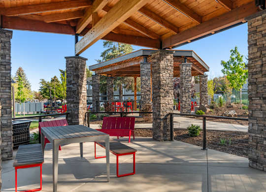 A covered patio area with a table and chairs.