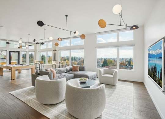 A modern living room with a large window and a pool in the picture on the wall.