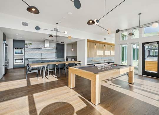 A modern kitchen with a dining table and chairs.
