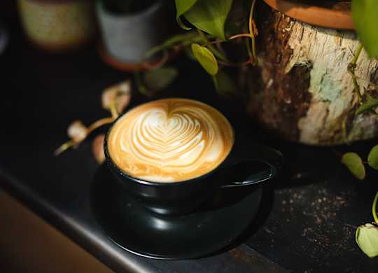 A cup of coffee with a heart design on top.