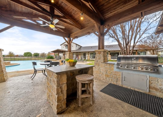 Villas at Sundance Apartments  covered outdoor kitchen with a grill and a pool