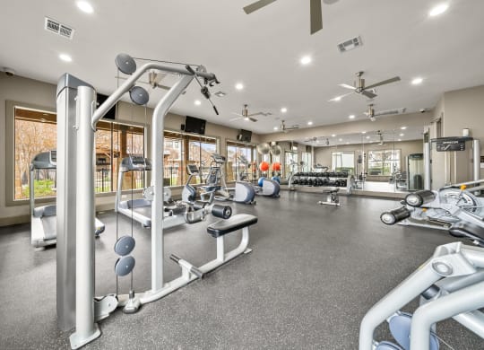 Villas at Sundance Apartments gym with weights and cardio equipment on the floor and a large window