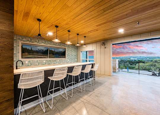 A wooden bar area with a view of the outdoors.