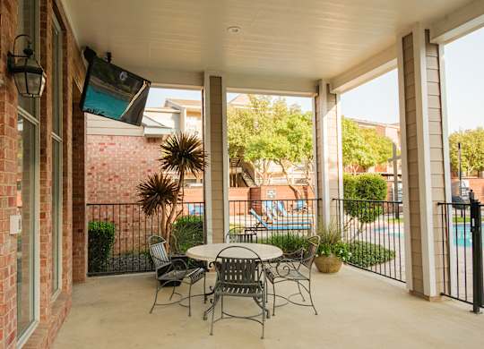 A patio with a table and chairs is shown.