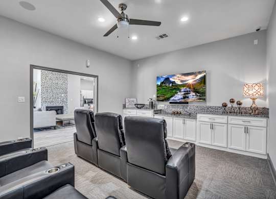 A modern living room with a large couch and a television.