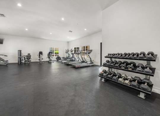 A spacious gym with a variety of exercise equipment.