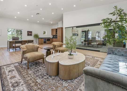 A living room with a grey couch and a wooden coffee table.