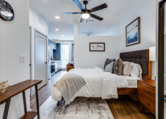 a bedroom with a bed and a ceiling fan