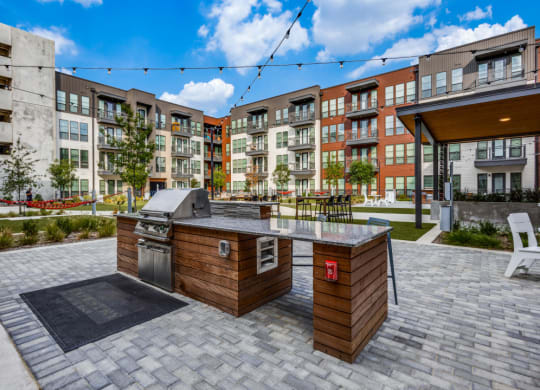 an outdoor entertaining area with a grill and a bar
