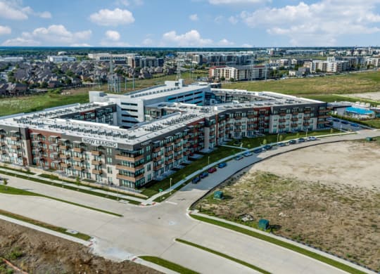 an aerial view of a building with a city in the background