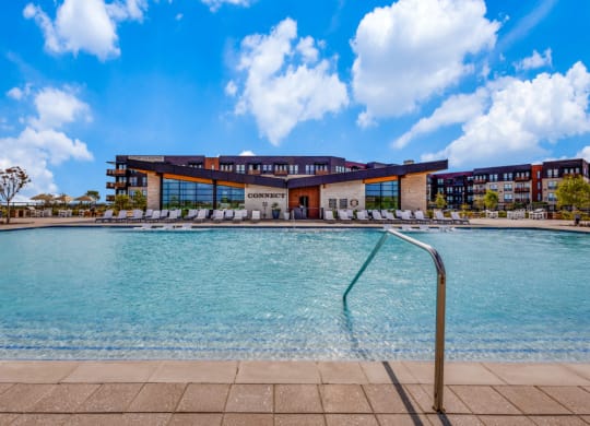 a large pool with a building in the background