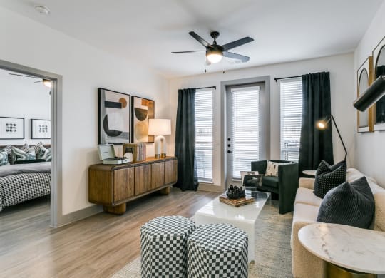 a living room with a couch and a ceiling fan