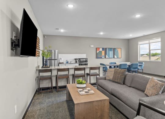 a living room with a couch and a table with chairs