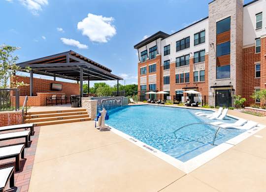 A swimming pool in a residential area with a building in the background.