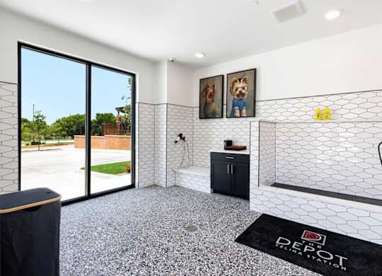 A bathroom with a black mat on the floor that says "DEPOT".