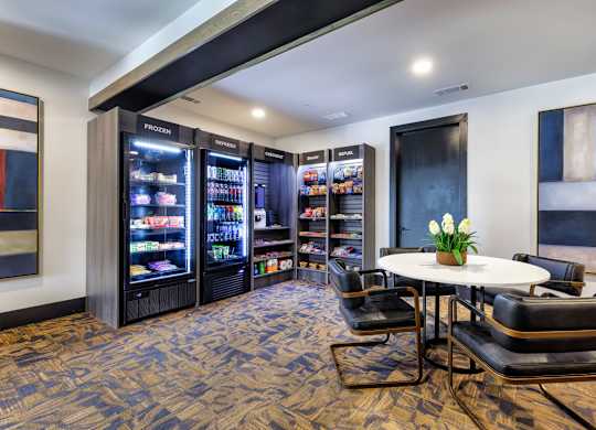 A room with a table, chairs and a frozen yogurt machine.